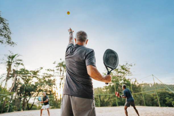 istock Senior men practicing beach tennis moment of serve 1486148872