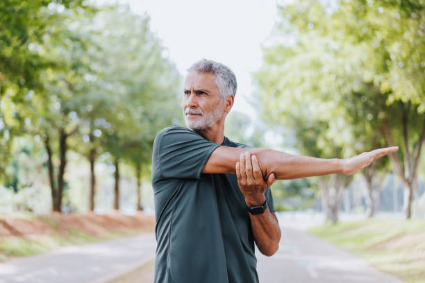 istock Serious senior man doing stretching in public park 1486149183