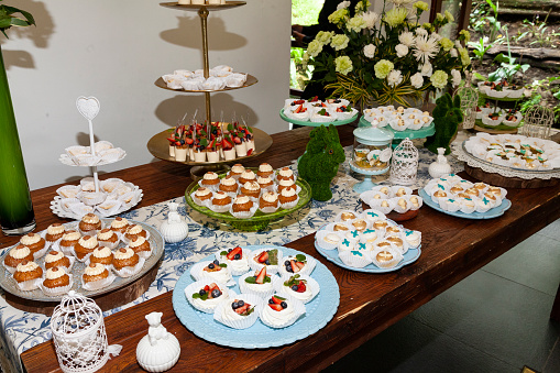 Reception Hall Decorated For Social Events; Dessert Table For Guests.