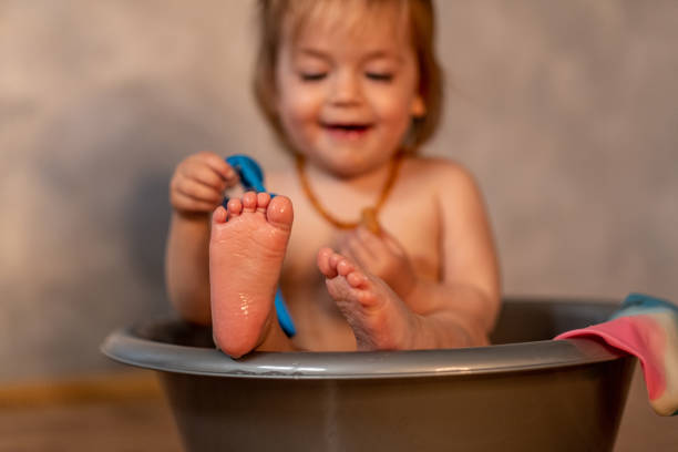 Cute baby feet on white background