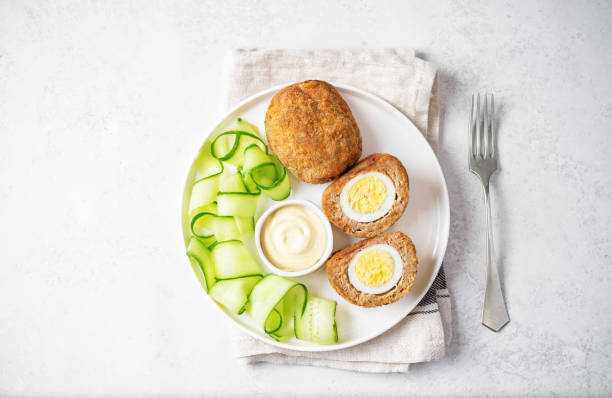 istock Scotch eggs with mustard suace and cucumbers 1486157790