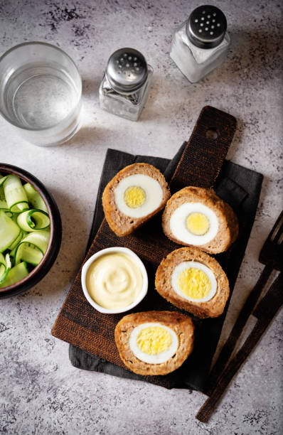 istock Scotch eggs with mustard suace and cucumbers 1486157794