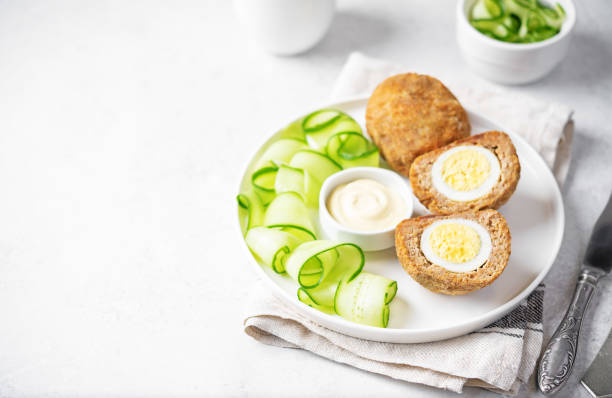 istock Scotch eggs with mustard suace and cucumbers 1486157795