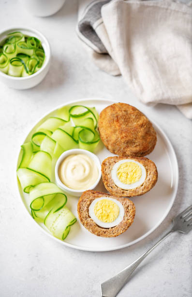 Scotch eggs with mustard suace and cucumbers