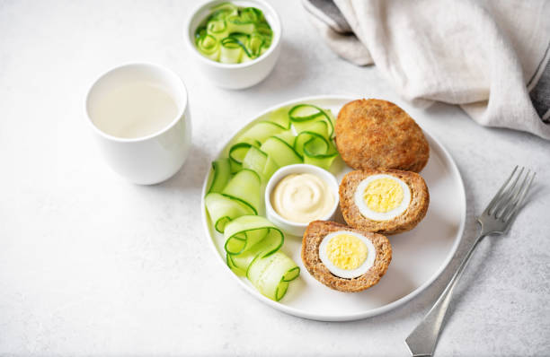 istock Scotch eggs with mustard suace and cucumbers 1486157797