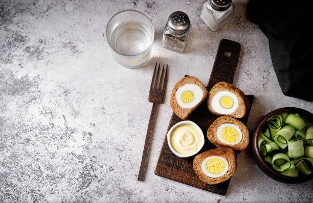 istock Scotch eggs with mustard suace and cucumbers 1486157805