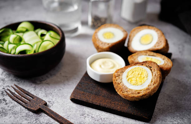 istock Scotch eggs with mustard suace and cucumbers 1486157808