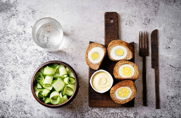 Scotch eggs with mustard suace and cucumbers