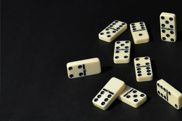 istock Dominoes on black background 1486158951