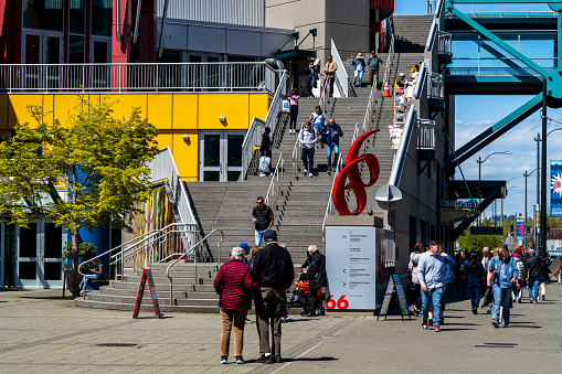 Seattle, Washington USA - April 26, 2023 : People walking at the Cruise Ship Terminal, Pier 66.