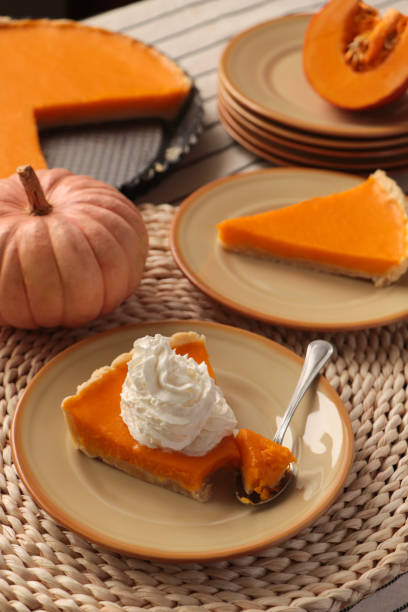 istock Fresh homemade pumpkin pie with whipped cream on table 1486168705