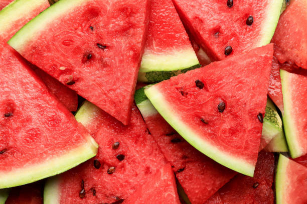 istock Slices of juicy ripe watermelon as background, top view 1486168708