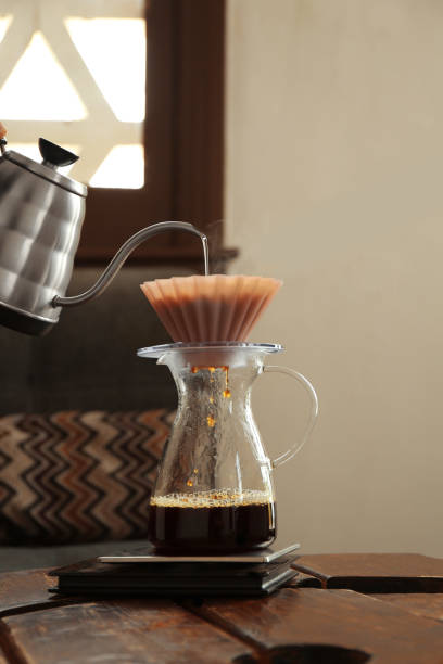 istock Preparing coffee at wooden table in cafe, closeup 1486168751