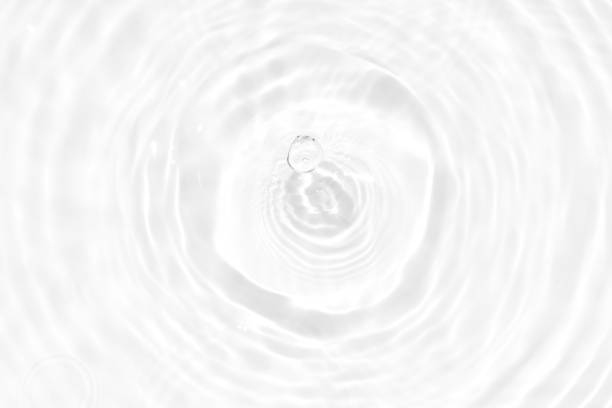 istock White water with ripples on the surface. Defocus blurred transparent white colored clear calm water surface texture with splashes and bubbles. Water waves with shining pattern texture background. 1486169264