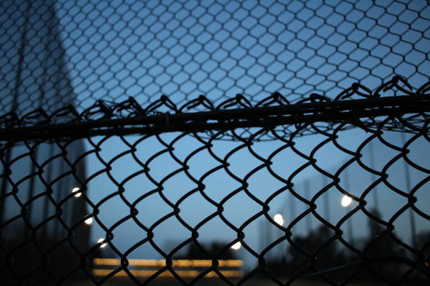 istock a picture of a golfing range through a fence hole 1486169989
