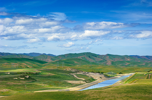 Springtime view of California coast range with the California Aqueduct in foreground.\n\nTaken in Central Coast of California.