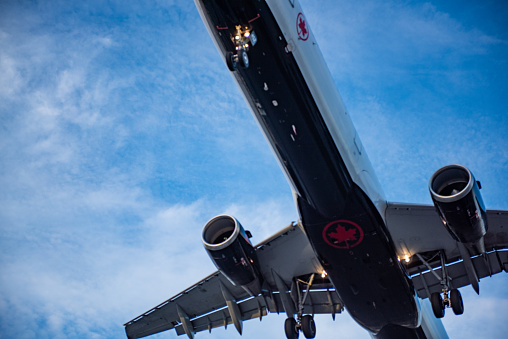 An airplane of Air Canada preparing to land on the runway in Pearson International airport at dusk, Toronto,Canada.