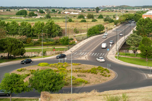 Roundabout with moving vehicles on a cloudy day.