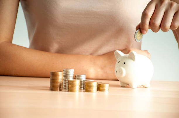 istock Young women are saving money, planning for home expenses, saving for financial status, saving for building a family. 1486175932