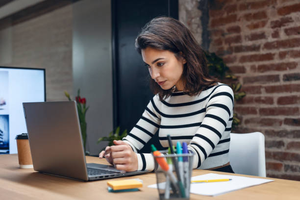 istock Architect engineer woman working with laptop while studying the blueprints in a modern office. 1486175978