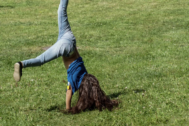 a young girl is playing outdoors in the summer