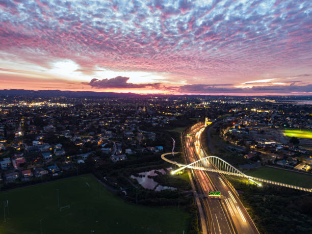 Southern Motorway 16 in the twilight Southern motorway 16 with a bridge over captured from up above with a drone in the sunset with cirrocumulus clouds cirrocumulus stock pictures, royalty-free photos & images