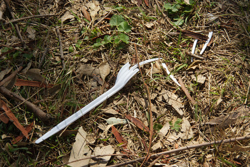 Broken plastic fork abandoned in public park