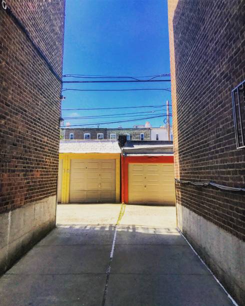 Garages in Queens, NYC Two garages share a driveway in Queens, NYC with a clear blue sky bronxville photos stock pictures, royalty-free photos & images