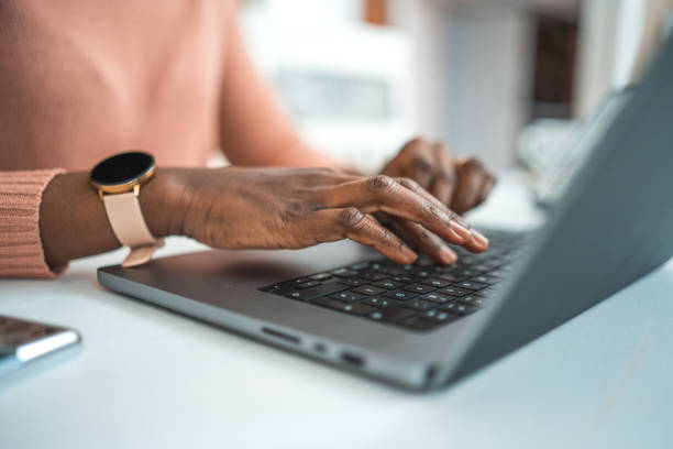 istock Black Female Typing On A Laptop 1486190650