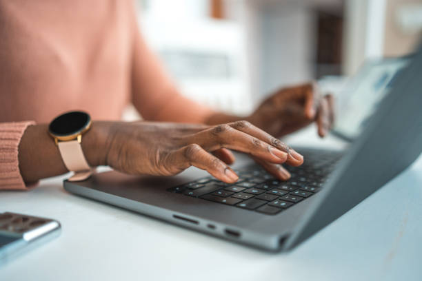 istock Black Female Typing On A Laptop 1486190654
