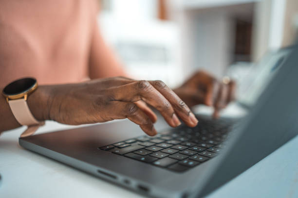 istock Black Female Typing On A Laptop 1486190656
