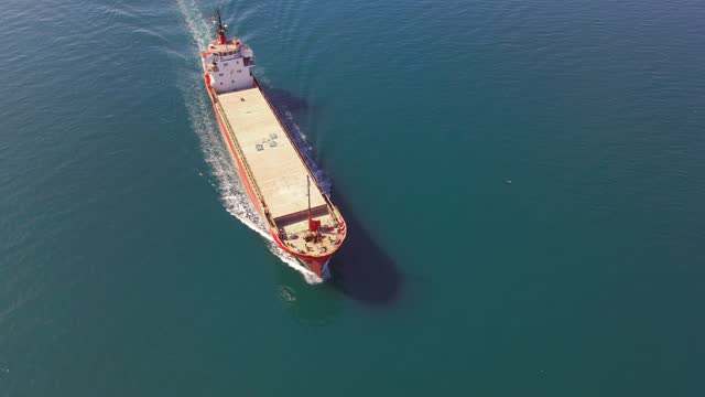 Dry cargo vessel underway on sea to port