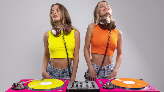 Twin female DJs with gramophones