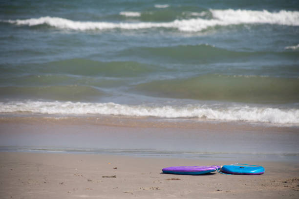 istock boogie board body board left abandoned on the beach object nobody copy space in front of ocean seaside 1486194787