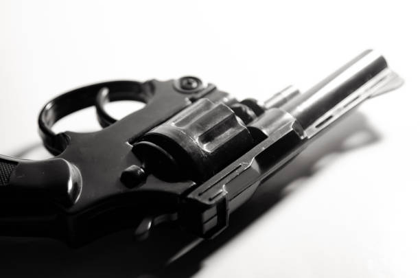 Gun in hand  dark tone in crime concept.