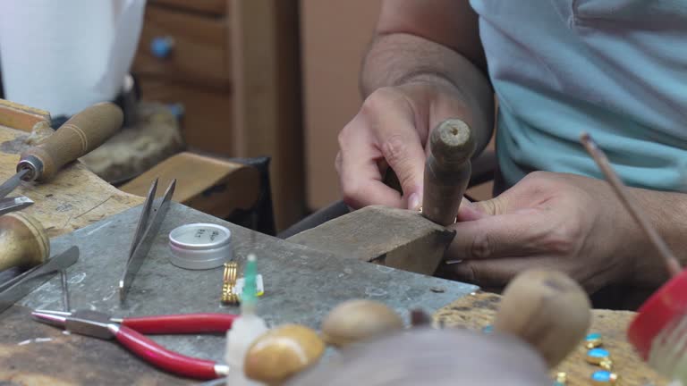 Close up of a jeweler's hands doing a repair