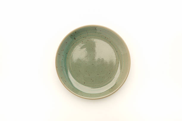 istock Top view of an empty green ceramic plate on a white background. 1486215293