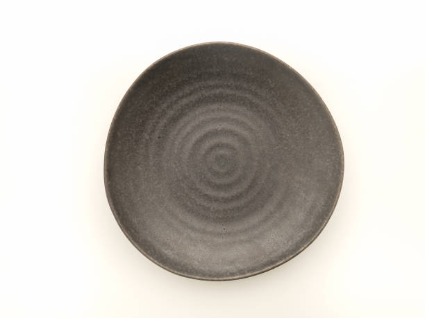 istock Top view of empty black ceramic plate on a white background. 1486215595