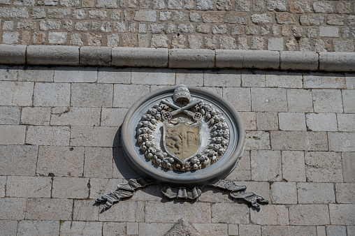Zamosc, Poland - May 2, 2016: Stone carved coat of arms of Tomasz Zamoyski from around 1620 on facade of 16th century Town Hall situated in the Main Square