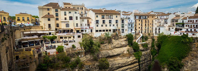 Ronda, Spain, April 2023: View on the restaurants and houses built on the cliffs on Puerte Nuevo in Ronda