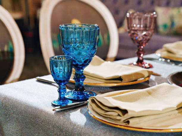 istock glasses of colored glass on a table with a blue tablecloth. 1486220988