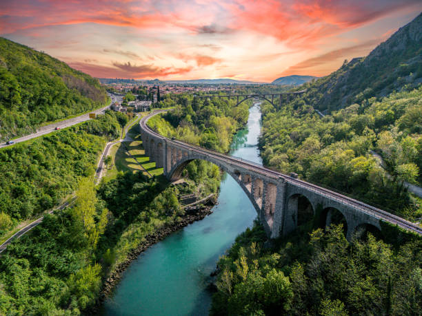 Amazing sunset view of a large stone railway bridge over beautiful green Soca river, aerial view Aerial view at sunset of  the Solkan Bridge, which is the world's longest stone arch railroad bridge. 219.7-meter (721 ft) stone arch bridge (viaduct) over the Soča River near Nova Gorica in Slovenia. nova gorica stock pictures, royalty-free photos & images