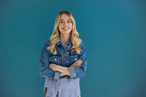 Beautiful blonde woman on blue background.