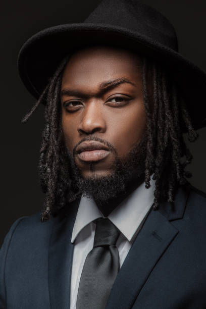 istock Handsome elegant black male posing for studio portrait wearing a hat 1486226569