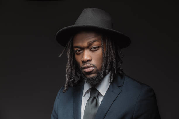 istock Handsome elegant black male posing for studio portrait wearing a hat 1486226573