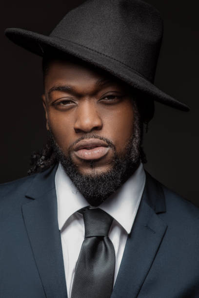 istock Handsome elegant black male posing for studio portrait wearing a hat 1486226583