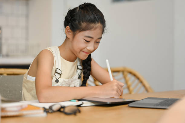istock E-learning, Online education concept with schoolgirl studying online with tablet and notebook. 1486226799