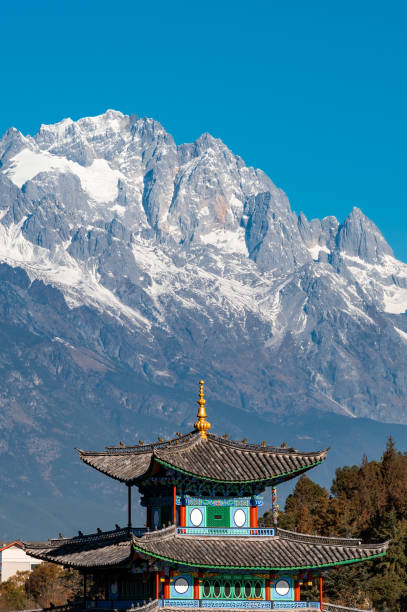 Yulong Snow Mountain in Lijiang, Yunnan Province, China The Yulong Snow Mountain features a traditional Chinese style tower as the foreground. yunnan province stock pictures, royalty-free photos & images