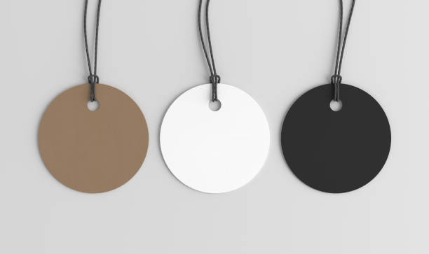 istock White, cardboard, black round tags mockup on white background. View directly above 1486226986