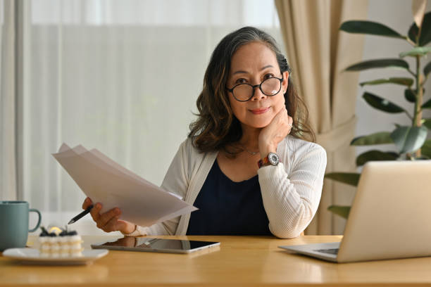 istock Smiling mature middle aged businesswoman using laptop for working, Work from home concept. 1486227024